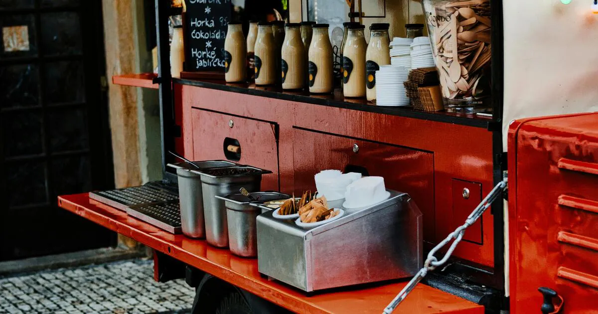 Food truck parked in winter with a bright service window